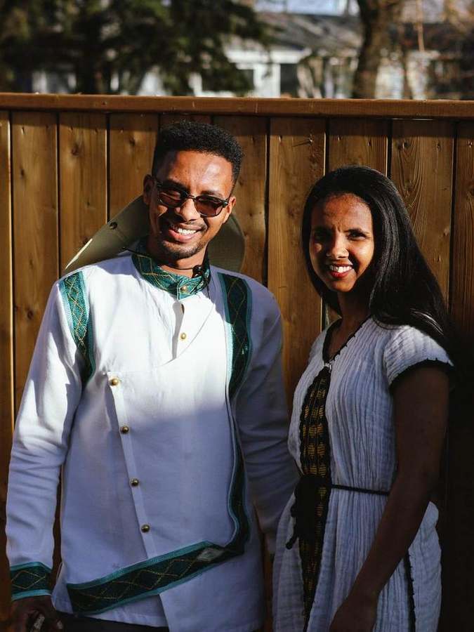 A couple smiling together by the fence