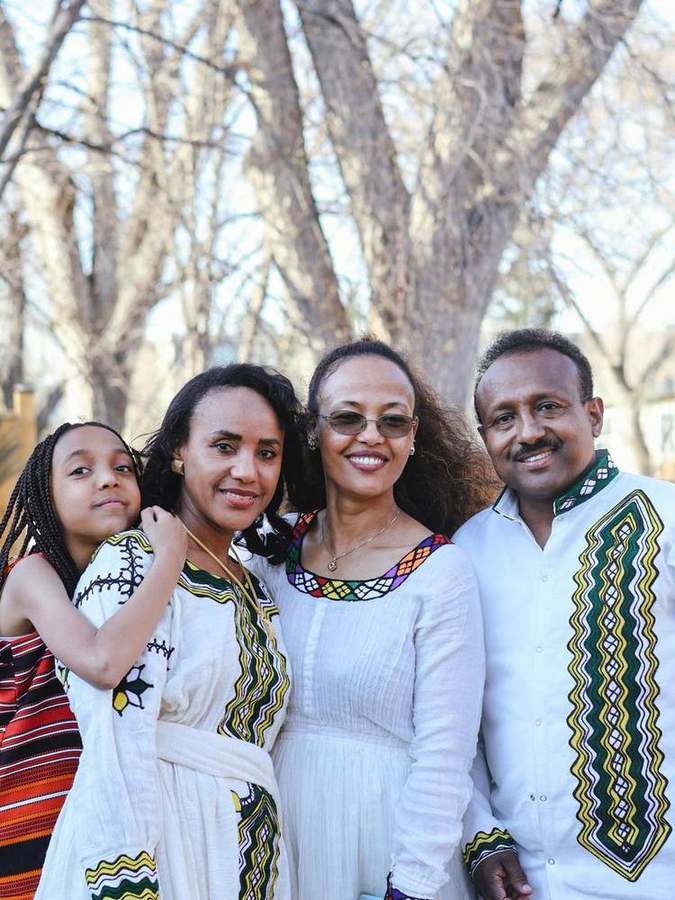 A family of four smiling together
