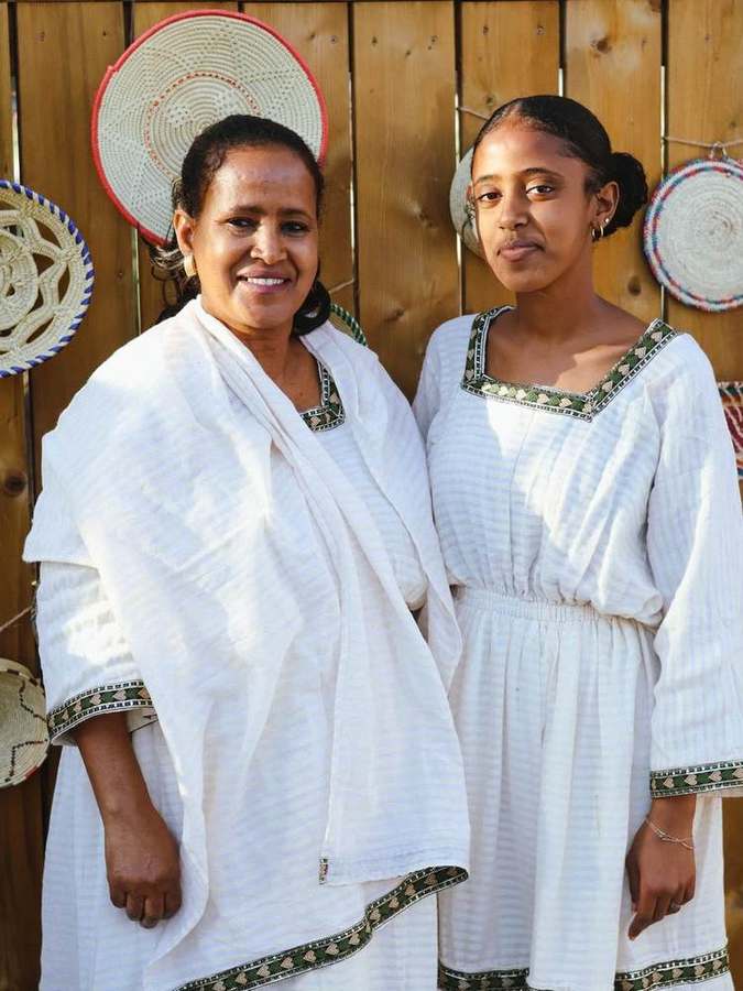 A mother and daughter smiling together
