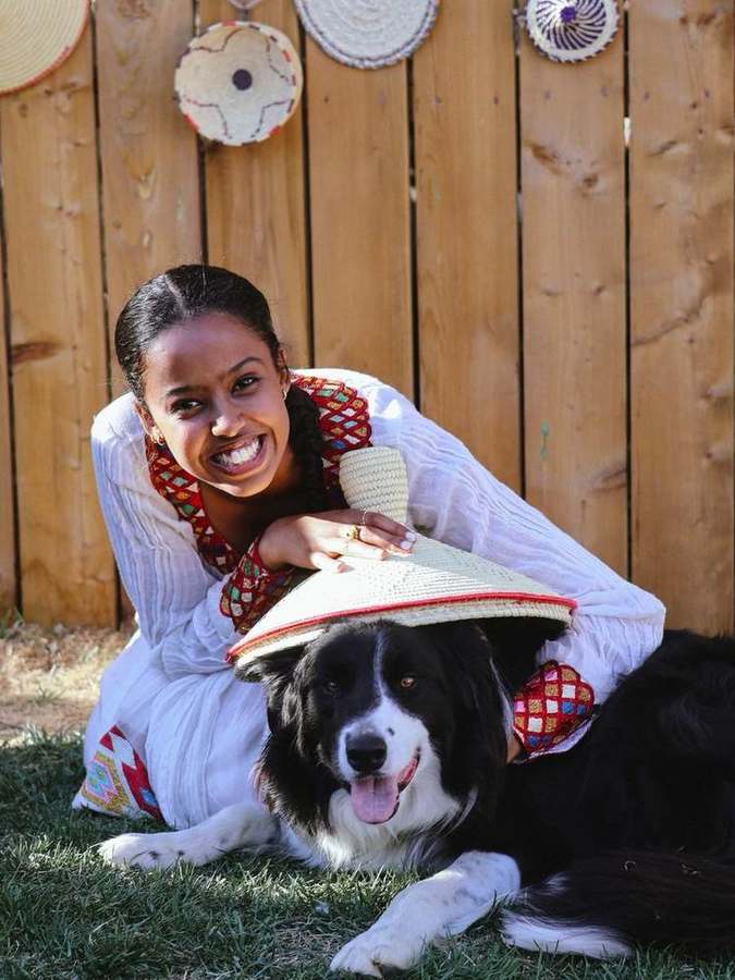 A woman smiling with her dog