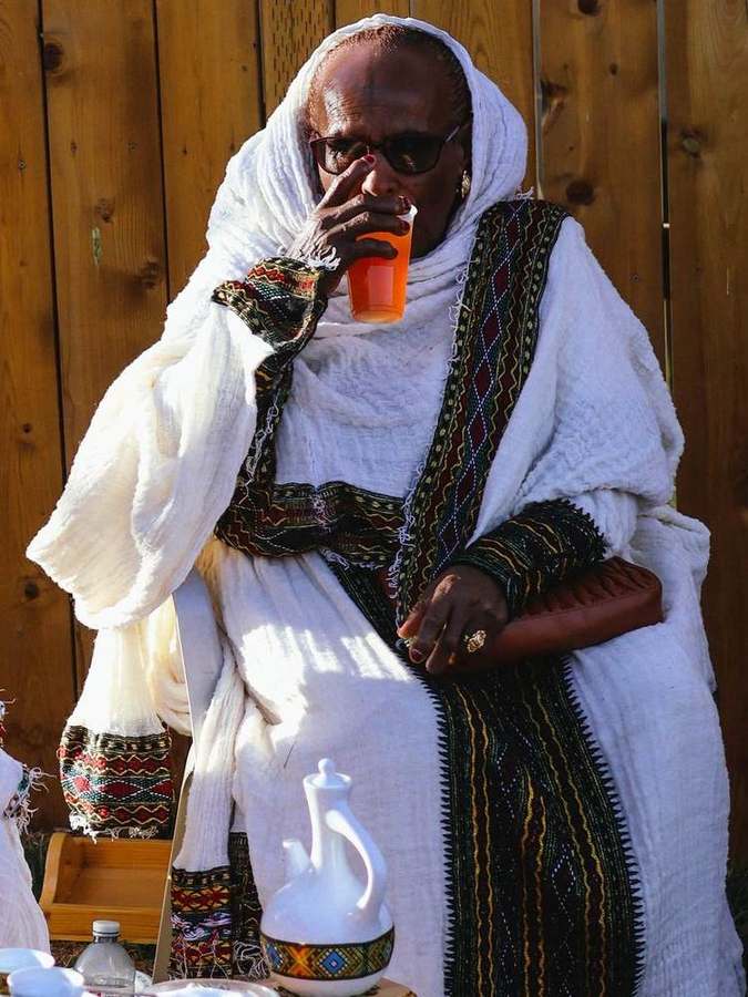 Elder woman sipping a drink