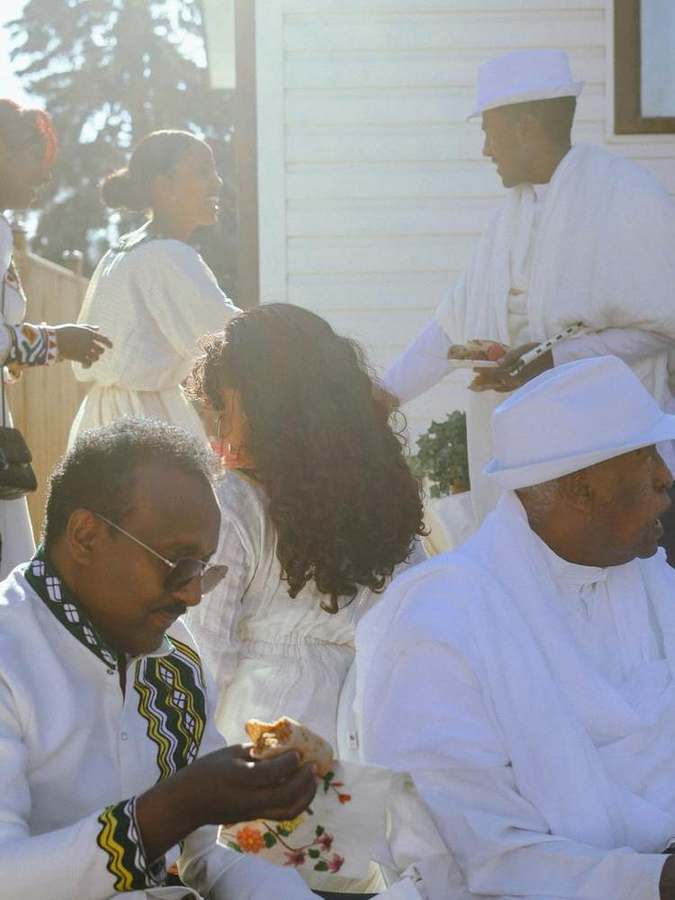Guests chatting and sharing food in the afternoon light