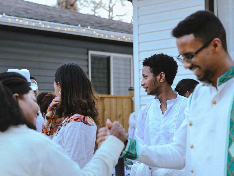Friends holding hands and laughing together