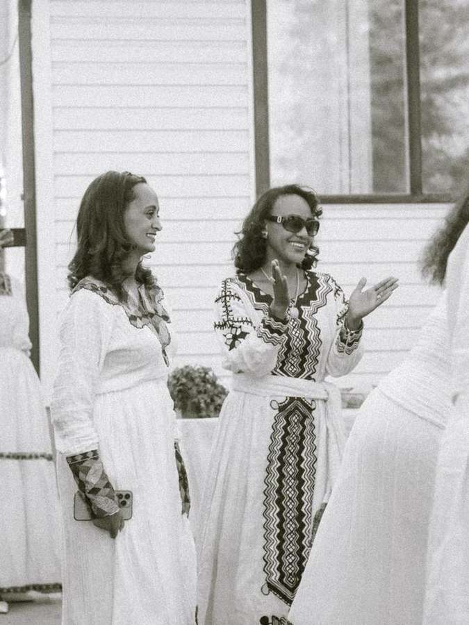 Two women chatting and clapping together