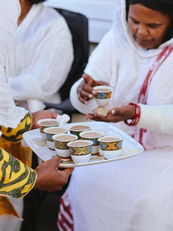 Serving a tray of coffee cups