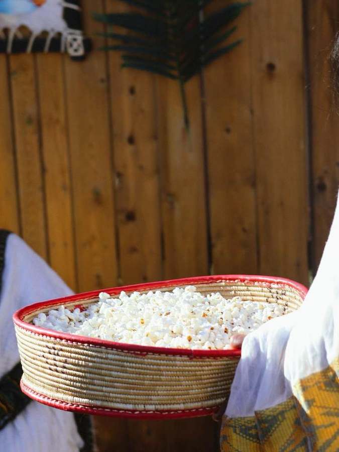 A woven basket of popcorn being served