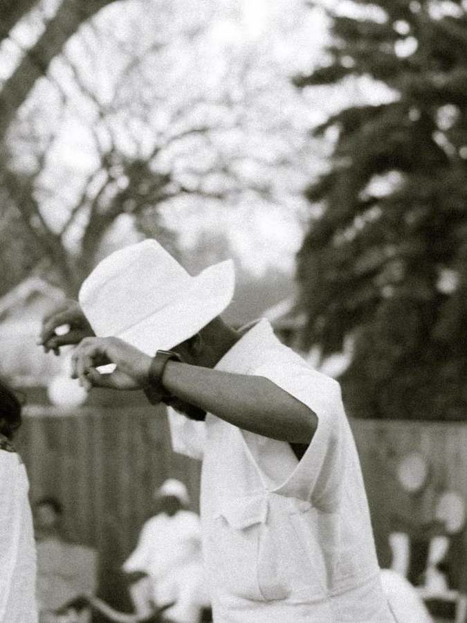 Man adjusting his hat mid-dance