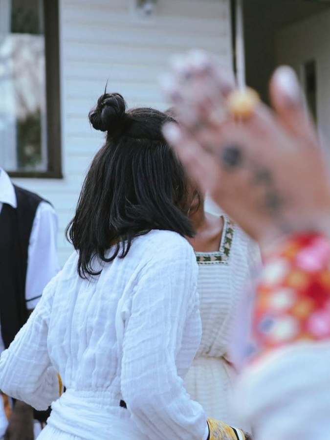 Detail of a woman's hair and henna-painted hand