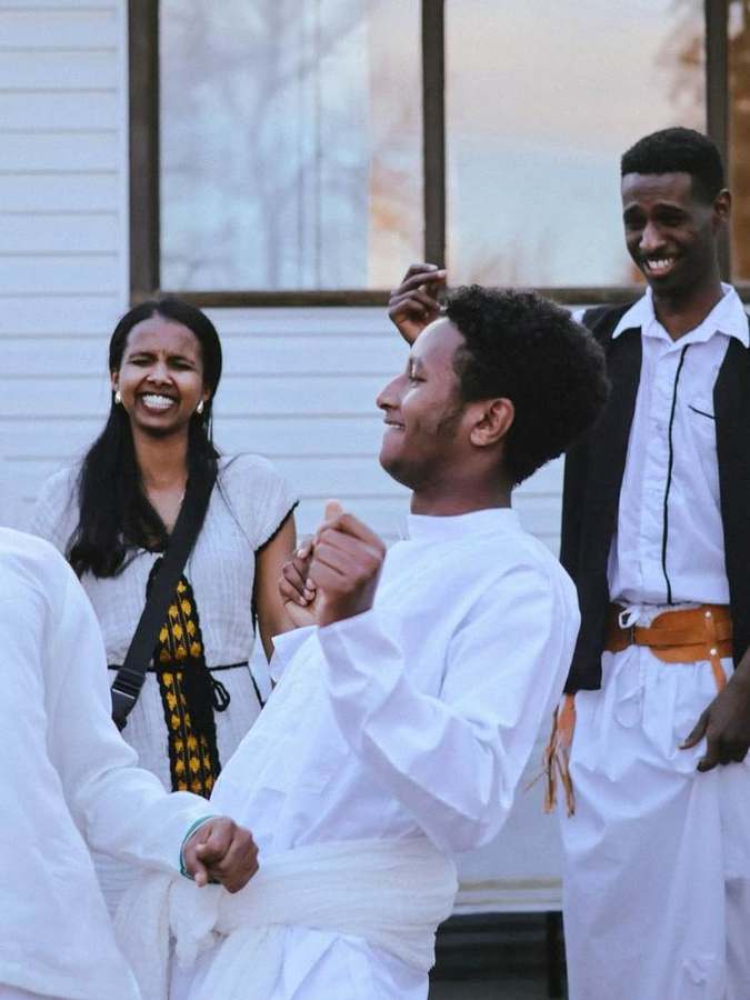 Friends dancing hand in hand, laughing