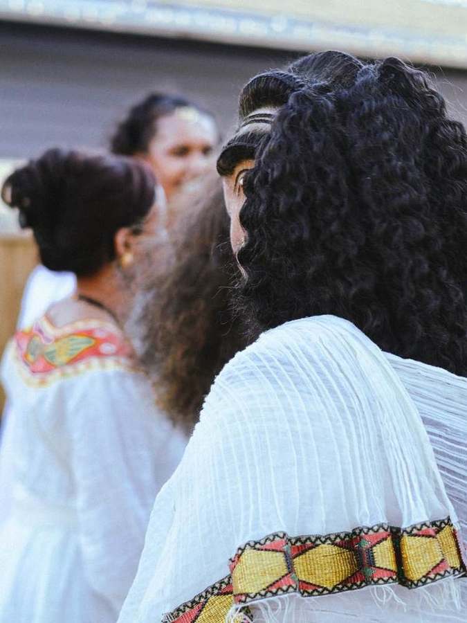 Detail of braided hair and an embroidered shoulder collar