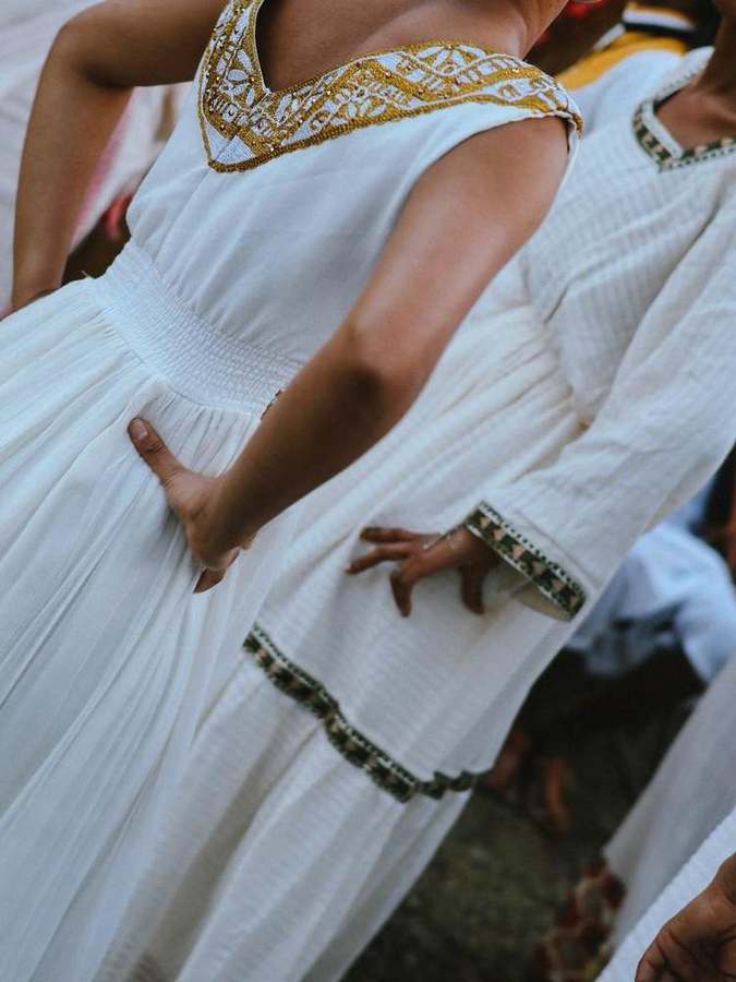 Detail of a dress with a gold embroidered neckline