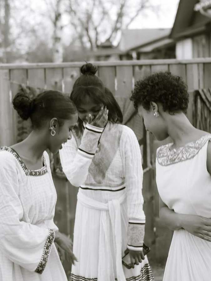 Three young women laughing together